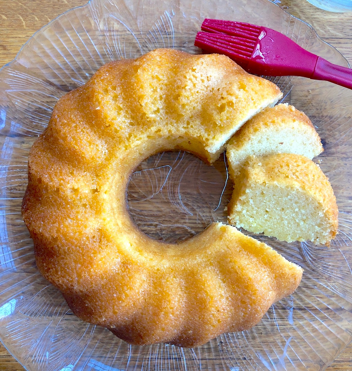 Lemon Bliss Cake on a plate, partially sliced 